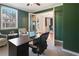 Well-lit office with a view to the yard and french doors, creating an inviting workspace at 6463 Century Park Se Pl, Mableton, GA 30126