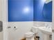 Charming powder room featuring classic wainscoting, stylish blue walls, and a pedestal sink at 6463 Century Park Se Pl, Mableton, GA 30126