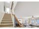 Carpeted staircase with a wooden railing ascends to the upper level, near a cozy living area at 6463 Century Park Se Pl, Mableton, GA 30126