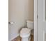 Powder room featuring a white toilet and tiled floors at 6463 Century Park Se Pl, Mableton, GA 30126