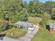 Aerial view of a charming home with a long driveway and lovely yard at 100 Charlotte Sw Dr, Mableton, GA 30126