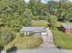 Aerial view of a charming home with a long driveway and lovely yard at 100 Charlotte Sw Dr, Mableton, GA 30126
