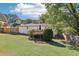 Large, private backyard with a deck, lawn, and mature trees at 100 Charlotte Sw Dr, Mableton, GA 30126