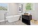 Bathroom showcasing a freestanding tub with modern fixtures and natural light from the window at 100 Charlotte Sw Dr, Mableton, GA 30126
