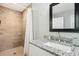 Bathroom featuring a tiled shower, a granite vanity with modern fixtures, and a stylish mirror at 100 Charlotte Sw Dr, Mableton, GA 30126