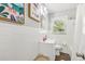 Bright bathroom features white tiled walls, modern vanity, framed art, and natural light from the window at 100 Charlotte Sw Dr, Mableton, GA 30126