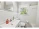 Bright bathroom featuring a white vanity with a stylish mirror and natural light streaming in from the window at 100 Charlotte Sw Dr, Mableton, GA 30126
