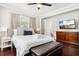 Inviting bedroom featuring dark wood floors, neutral walls, a queen bed, and an ensuite bathroom at 100 Charlotte Sw Dr, Mableton, GA 30126