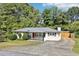 View of a well-maintained home featuring a driveway and a fenced backyard at 100 Charlotte Sw Dr, Mableton, GA 30126