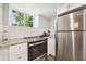 Compact kitchenette features stainless steel appliances, white subway tile backsplash, and granite countertops at 100 Charlotte Sw Dr, Mableton, GA 30126