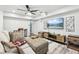 Comfortable living room featuring a neutral color palette, modern ceiling fan, and a mounted television at 100 Charlotte Sw Dr, Mableton, GA 30126