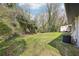 Green backyard offers space for outdoor activities, with a shed and HVAC unit visible at 1751 Carter Cir, Atlanta, GA 30344