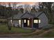 Charming home featuring gray siding, a welcoming front porch, and well-maintained landscaping at 1751 Carter Cir, Atlanta, GA 30344