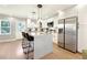 Bright kitchen features white cabinets, stainless steel appliances, and a quartz island with pendant lighting at 1751 Carter Cir, Atlanta, GA 30344
