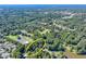 Lush aerial view highlighting property, lake access, and neighborhood amenities surrounded by dense trees at 2962 Norman Cir, Duluth, GA 30096