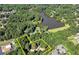 Aerial view showing the lot line near a lake, mature trees, and houses at 2962 Norman Cir, Duluth, GA 30096