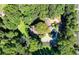 Stunning aerial shot of a secluded home enveloped by dense trees, featuring a pool and meticulously landscaped grounds at 2962 Norman Cir, Duluth, GA 30096