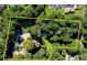 Aerial view showing a lot line containing a house with a pool and lots of mature trees at 2962 Norman Cir, Duluth, GA 30096