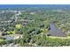Expansive aerial view showing a community near a lake surrounded by lush, mature trees at 2962 Norman Cir, Duluth, GA 30096