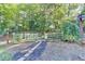 Backyard space with a wooden gate, a short stone walking path, and lush green foliage at 2962 Norman Cir, Duluth, GA 30096