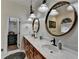 Bathroom featuring double sinks, elegant mirrors, and a soaking tub with decorative art at 2962 Norman Cir, Duluth, GA 30096