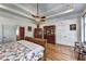 Bright bedroom featuring a tray ceiling, hardwood floors, and decorative furniture creating a warm, inviting atmosphere at 2962 Norman Cir, Duluth, GA 30096