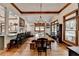 Large dining area with vaulted ceilings, hardwood floors, modern chandelier, and an open design to adjacent living areas at 2962 Norman Cir, Duluth, GA 30096