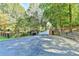Long driveway lined with trees and a wooden fence leading up to the home at 2962 Norman Cir, Duluth, GA 30096