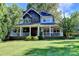Charming two-story home with a covered porch, manicured lawn, and mature landscaping at 2962 Norman Cir, Duluth, GA 30096