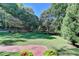 Expansive front lawn with mature trees and lush landscaping offers a park-like setting at 2962 Norman Cir, Duluth, GA 30096