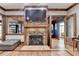 Elegant living room with stone fireplace, TV, hardwood floors, and beautiful wood trim at 2962 Norman Cir, Duluth, GA 30096