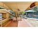 Covered outdoor dining area with dining table near the pool and television at 2962 Norman Cir, Duluth, GA 30096