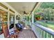 Inviting covered front porch with hanging flowers, ceiling fan, and comfortable seating area to enjoy the outdoors at 2962 Norman Cir, Duluth, GA 30096