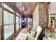Bright sunroom featuring large windows offering views of the backyard and a comfortable seating area at 2962 Norman Cir, Duluth, GA 30096