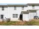 Backyard with lush green grass, partial fence, and two-story condo building at 4457 Watson Ridge Dr, Stone Mountain, GA 30083