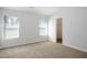 Bright bedroom with neutral carpet, closet, and multiple windows, creating a serene and comfortable retreat at 4457 Watson Ridge Dr, Stone Mountain, GA 30083