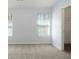 Bright bedroom with neutral walls, carpet, two windows with blinds and walk-in closet at 4457 Watson Ridge Dr, Stone Mountain, GA 30083