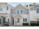 Charming townhouse featuring a modern white and gray exterior with a welcoming front porch at 4457 Watson Ridge Dr, Stone Mountain, GA 30083