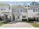 Well-maintained townhome with a front yard and modern exterior design showcasing curb appeal at 4457 Watson Ridge Dr, Stone Mountain, GA 30083