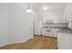 This kitchen features white cabinets, granite countertops, appliances, and stylish wood-look floors, enhancing its appeal at 4457 Watson Ridge Dr, Stone Mountain, GA 30083