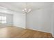 Large living area with hardwood floors, lots of natural light, and a classic chandelier at 4457 Watson Ridge Dr, Stone Mountain, GA 30083