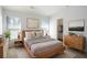 Bright main bedroom with modern furniture, large windows, and a view into a walk-in closet at 4457 Watson Ridge Dr, Stone Mountain, GA 30083