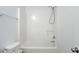 Clean white shower tub with tiled walls and granite vanity at 4457 Watson Ridge Dr, Stone Mountain, GA 30083
