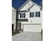 Charming exterior elevation featuring white siding, black shutters and a convenient two car garage at 6324 Rosetta Drive, Lot 2, South Fulton, GA 30331