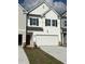 Charming exterior elevation featuring white siding, red front door, black shutters and a two car garage at 6324 Rosetta Drive, Lot 2, South Fulton, GA 30331