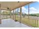 Screened in back porch featuring a fan, outdoor carpet, and views of the backyard at 1105 Alaska St, Hampton, GA 30228