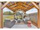 Backyard covered patio featuring outdoor seating and a grill at 1105 Alaska St, Hampton, GA 30228