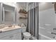 Clean bathroom with a white vanity, toilet, and a shower with a gray curtain at 1105 Alaska St, Hampton, GA 30228