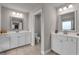 Bright bathroom featuring double vanities, neutral tile flooring, and modern lighting at 1105 Alaska St, Hampton, GA 30228