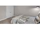 Relaxing bedroom with neutral tones and comfortable bed by a set of double doors at 1105 Alaska St, Hampton, GA 30228